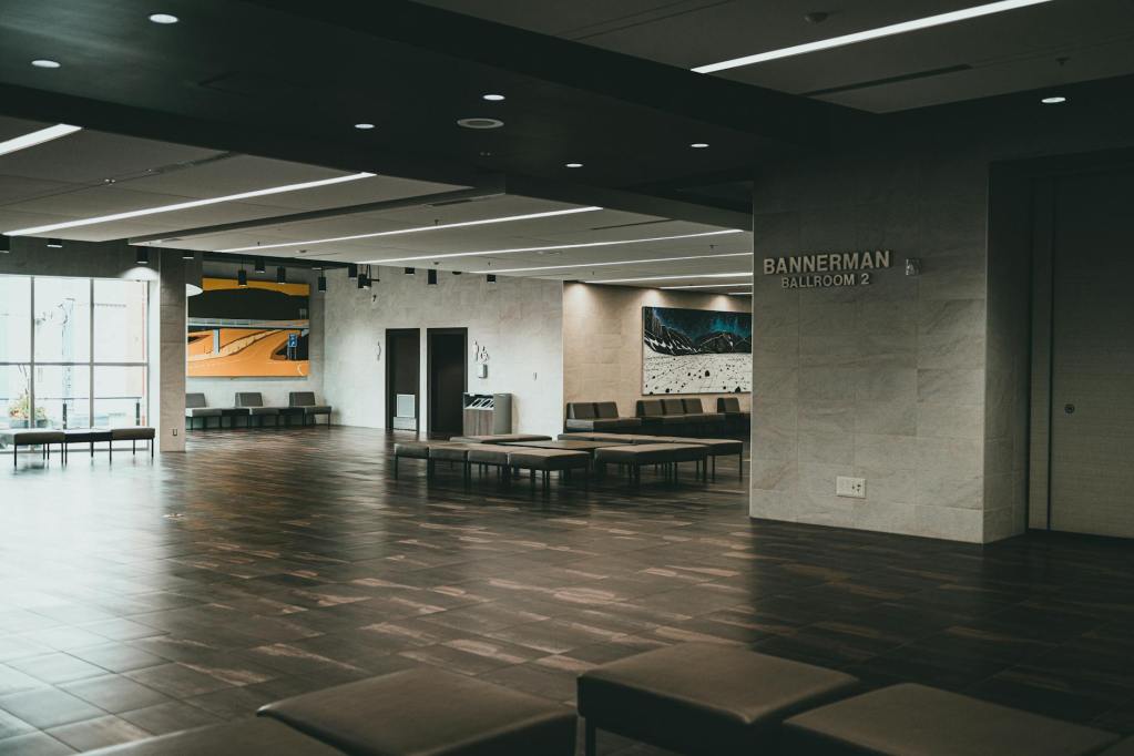 the lobby of a building with a large wooden floor